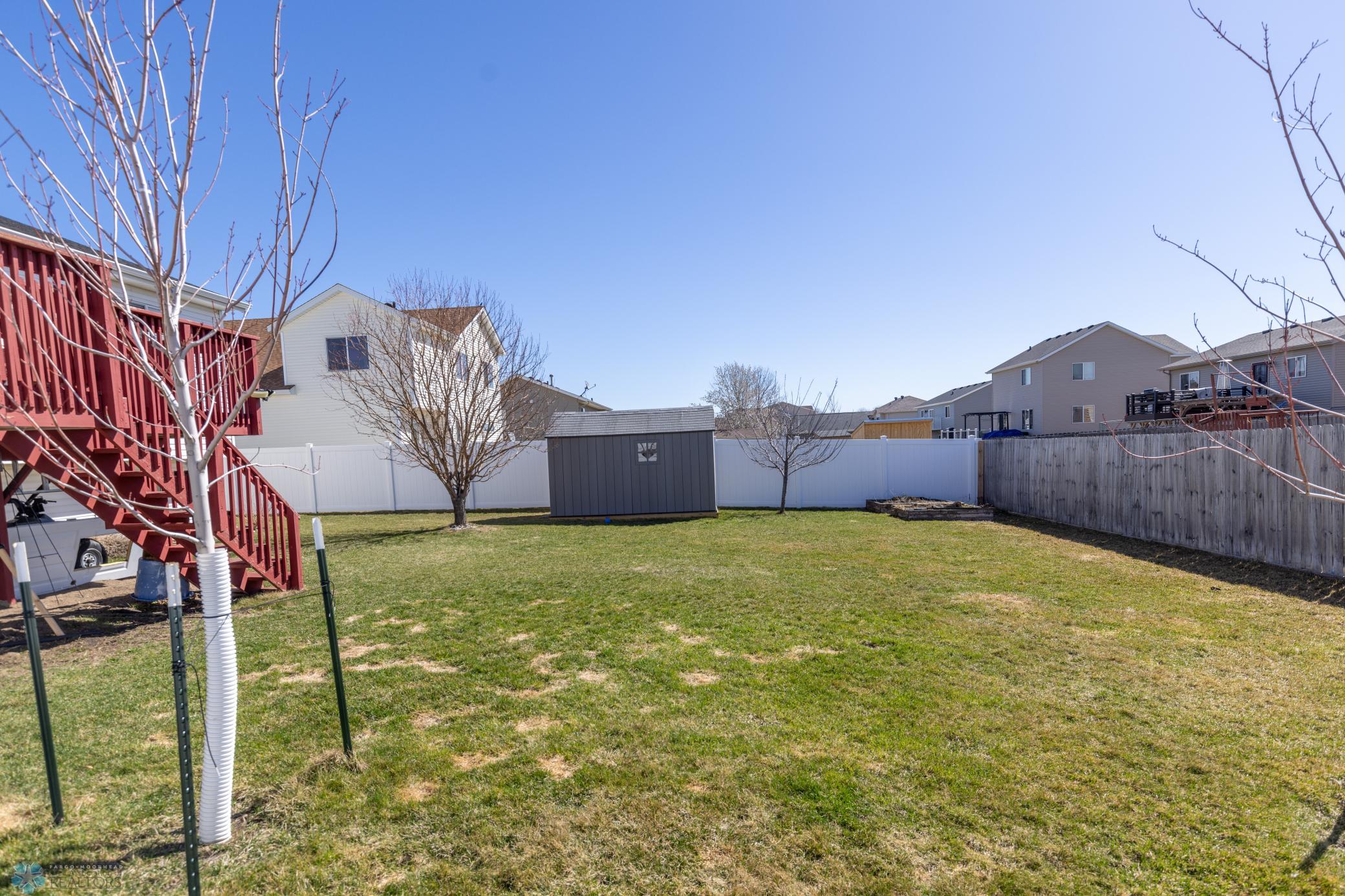 2 raised gardens in far corner of the backyard.
