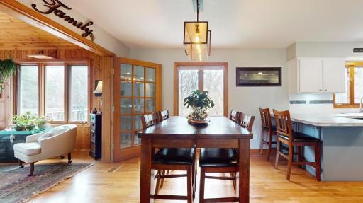 Open Dining Room with hardwood floors and updated bronze light fixture