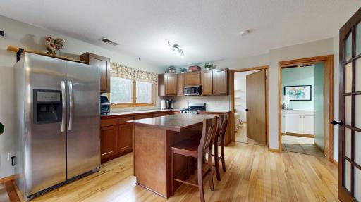 Lower level dry Kitchen (no sink) with center island, engineered hardwood floors and ss appliances