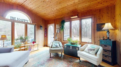 4 Season Porch with knotty pine ceilings and walls plus deck access