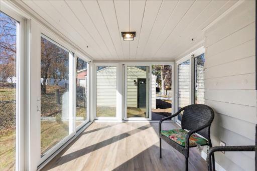 Beautiful sunroom with windows on three sides. Perfect for welcoming the new day, or watching the sun set...warm and inviting!