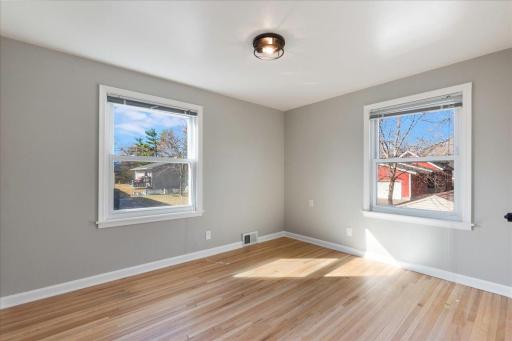Bask in the natural light from two side windows, with gleaming hardwood floors adding a touch of elegance.