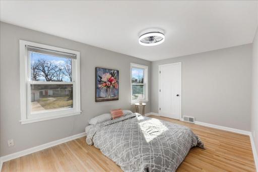 Indulge in the beauty of this bedroom featuring two windows, rich hardwood flooring, and a generously sized closet.