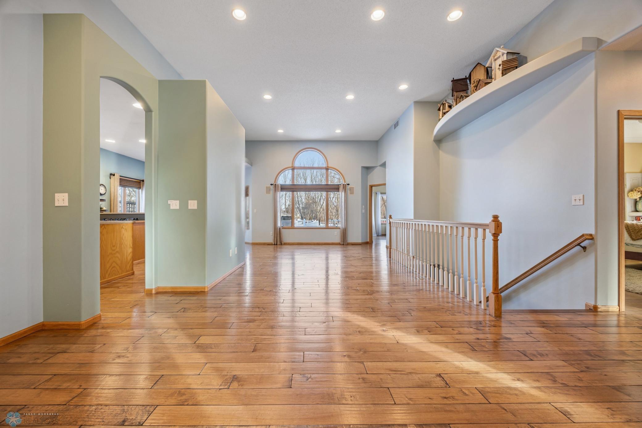 Welcoming and open main floor with Acer Maple hardwood floors.