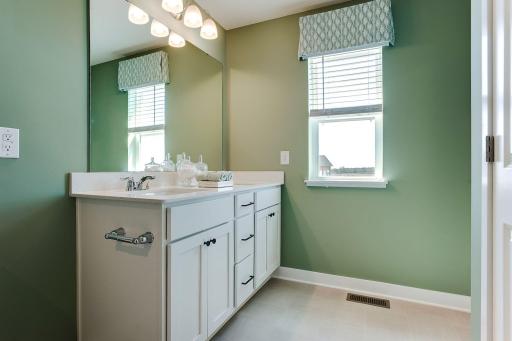 Dual vanity in the primary bathroom! Photo of model home, colors will vary.