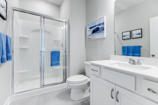 Main level bath with shower. *photo of a model home, selections and finish will vary.