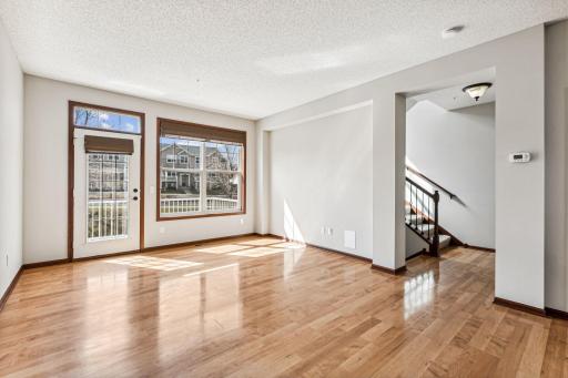 Living room is filled with natural light and has gleaming hardwood floors!
