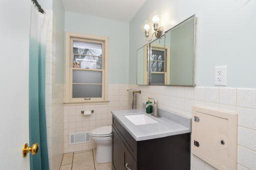 Bathroom updated vanity, sink, toilet, tile flooring & lighting