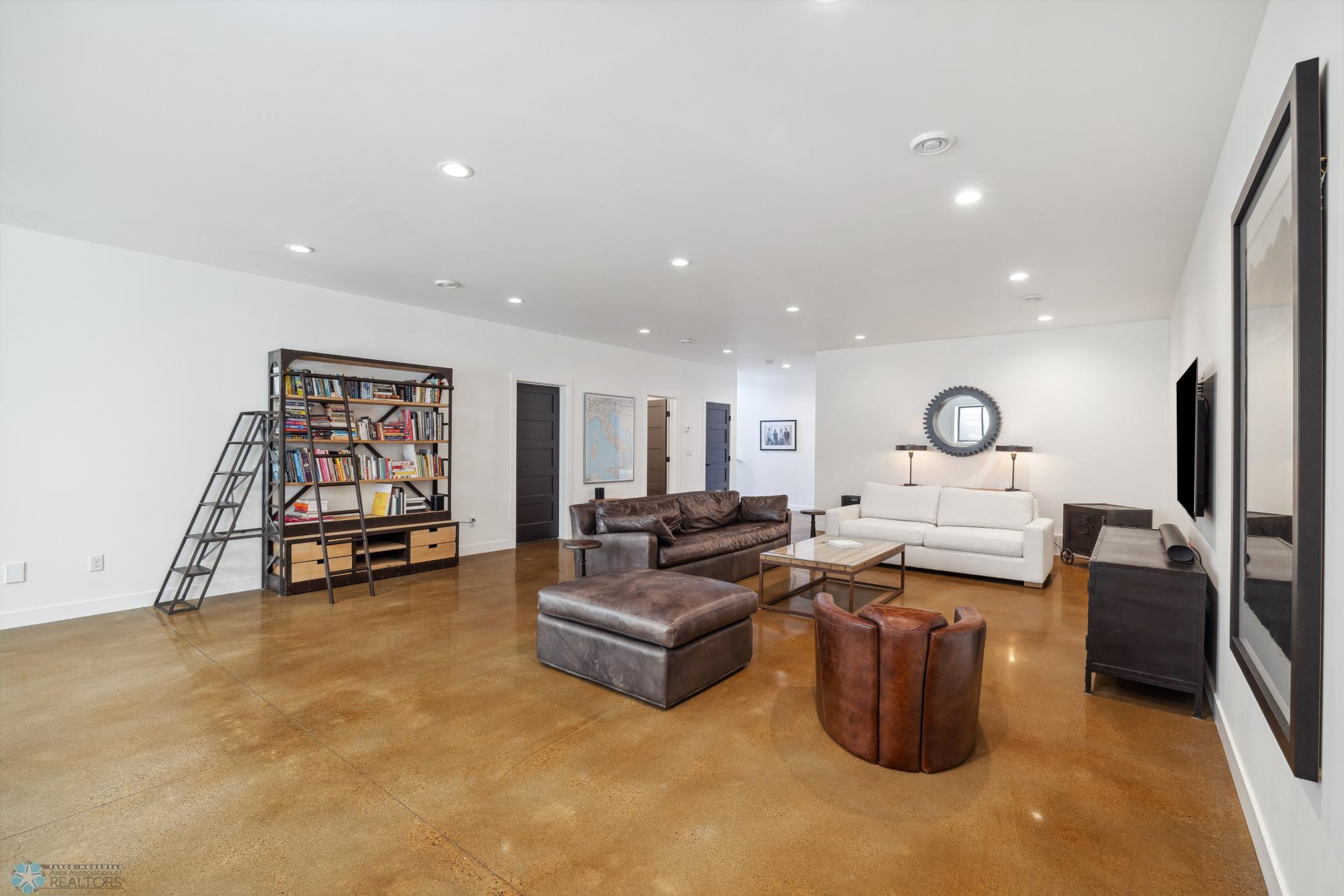 Basement Living Area Featuring Polished Concrete Floors Throughout