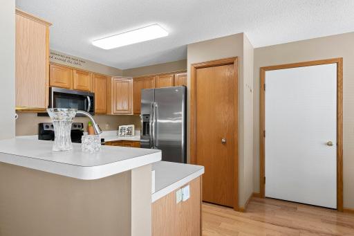 Discover a fantastic kitchen equipped with sleek stainless steel appliances, including a brand-new microwave, perfect for culinary endeavors.