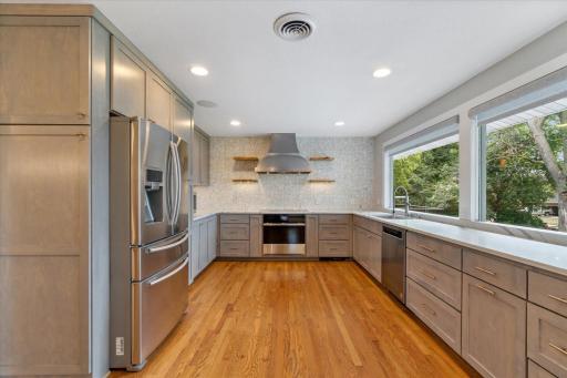 There is a lot of counter space with stunning quartz counters along with loads of cabinets with a tremendous amount of storage.