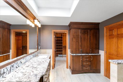 The primary bathroom has a custom built-in floor-to-ceiling linen closet.