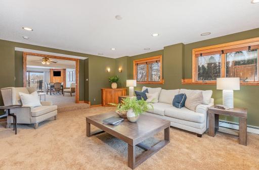 The lower level sunk-in family room has large pocket doors that can close the room off for privacy or a movie night!