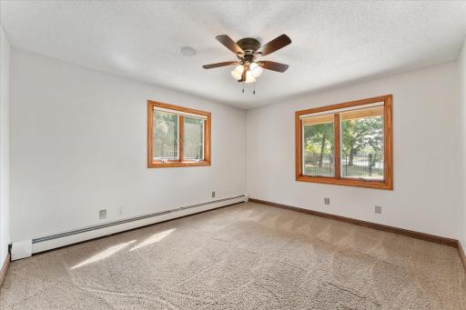 First bedroom in the lower level has windows with a lake view.