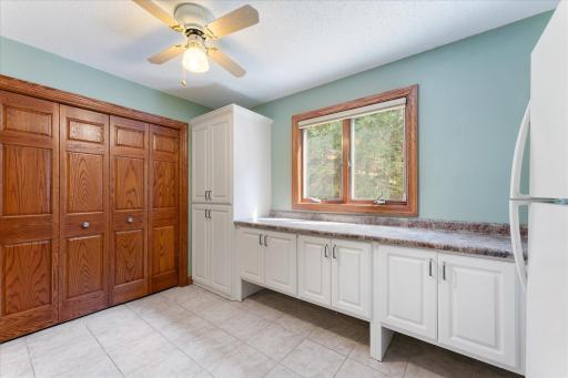 Lower-level laundry room has three different linen closets with built-in shelves.