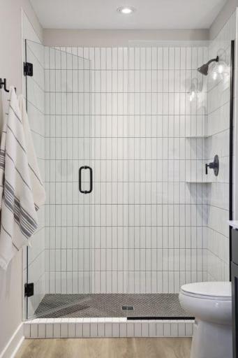 Beautiful tiled shower with frameless glass shower door