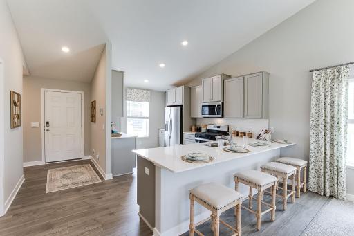 This functional kitchen boasts 42' cabinets with hardware, stainless steel appliances and quartz countertops. Photo is of model home. Colors and options may vary. Ask Sales Agent for details.