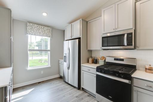 Stainless steel appliances and quartz countertops. Photo is of model home. Colors and options may vary. Ask Sales Agent for details.