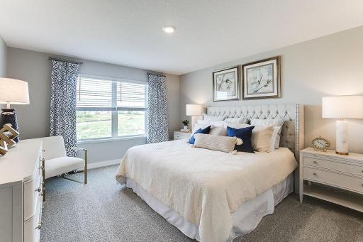 An oasis of its own, the primary suite offers the perfect escape. There's immediate access to a private bathroom that features dual sinks and a large shower. Photo is of model home. Colors and options may vary. Ask Sales Agent for details.