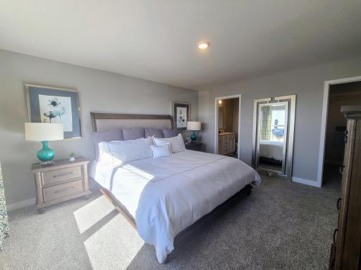 Owner's suite with bathroom en-suite. Photo is of model home. Colors and options may vary. Ask Sales Agent for details.