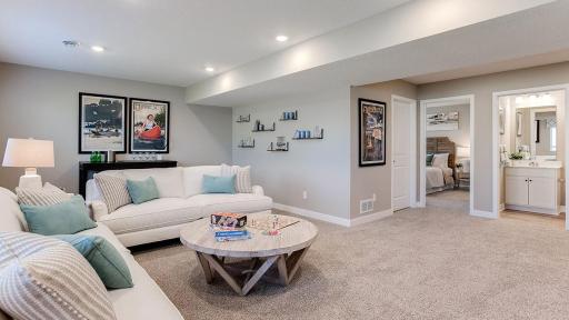 Once downstairs, the entire level flows from the focal point offered by this huge family room. Sure to become a family favorite hangout spot, the room is just steps from the lower level bedroom and bathroom! Photo is of model home.