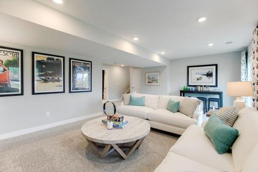 View of the lower level family room...Just a tremendous use of space!! Photo is of model home. Colors and options may vary. Ask Sales Agent for details.