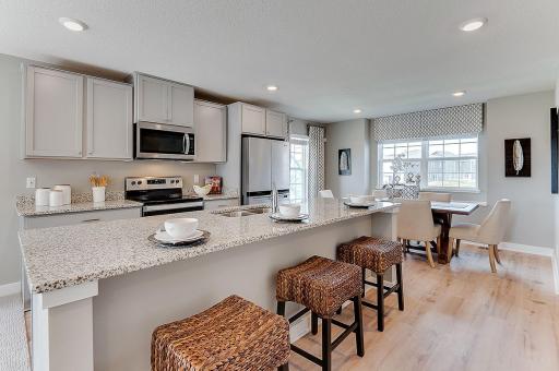 Kitchen and dining flow nicely in this open concept plan. Model home, details will vary.