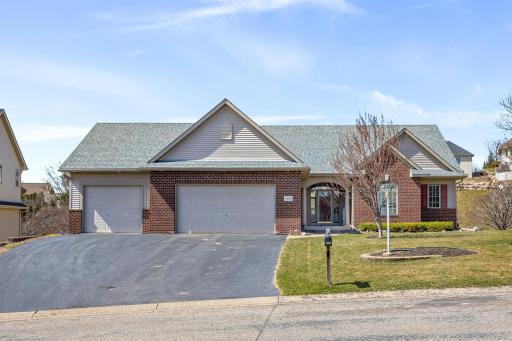 Hard to find rambler has so many extras, including front door w/transom & sidelite windows, plus flanked by columns. Home has gutters, an irrigation system & lovely landscaping. In addition to the 3 car garage, there is a 4th stall in the lower lvl
