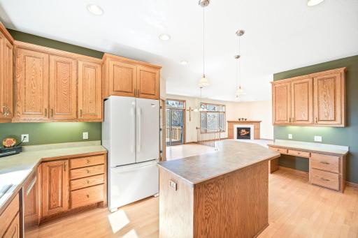 Large kitchen includes an island, desk, and tons of oak cabinetry.