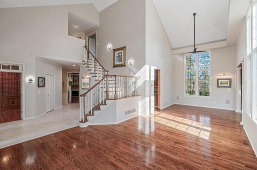 The tiled floor leads to the kitchen and dining room, and the gleaming oak floor leads to the other gracious living spaces.