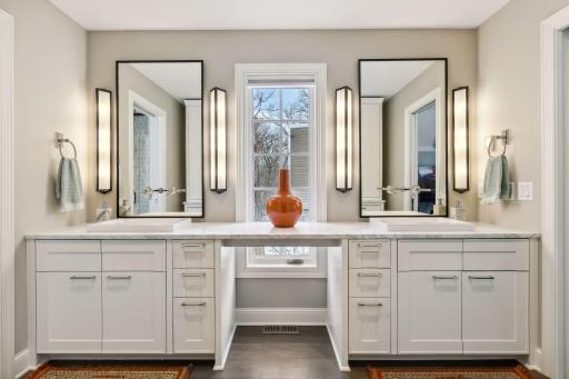 Primary bath has honed Carrara marble countertops, heated floors and duel vanities with an optional makeup area. Custom mirrors with ROHL faucets and semi-recessed sinks not only modernizes this bath, but will take it into the years to come.