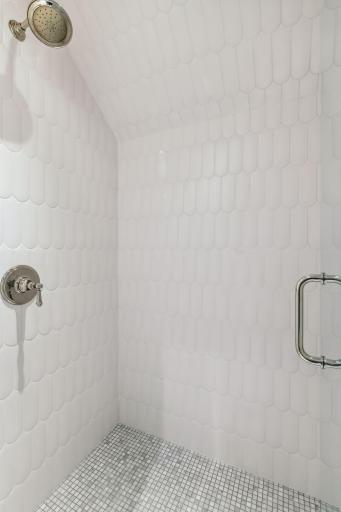 Upper east bath shower has the most unique matte white fish-scale tile. You have to see it in person to truly appreciate it.