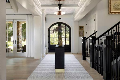 Instant elegance and extraordinary light will welcome you. Artistic hand-crafted lighting inside this airy 10' ceiling foyer.