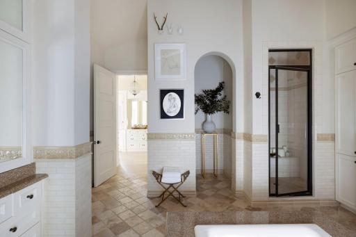 Heated Travertine Tile Floors provide warmth and comfort under foot. A steam shower and newly updated closets have been installed