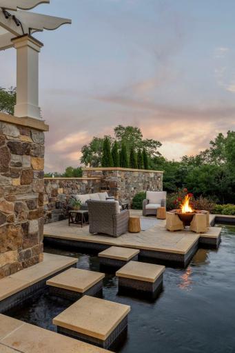 The stone walls create the perfect privacy backdrop for this extraordinary outdoor room, surrounded by water.