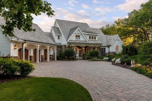 A long paver driveway meets a heated 3-car garage, 28 feet deep with an apoxy floor finish.