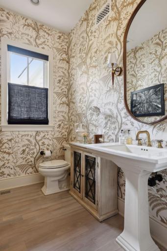 Custom designed wallpaper designed by Kelli Fontana creates a stunning backdrop to this gorgeous powder room