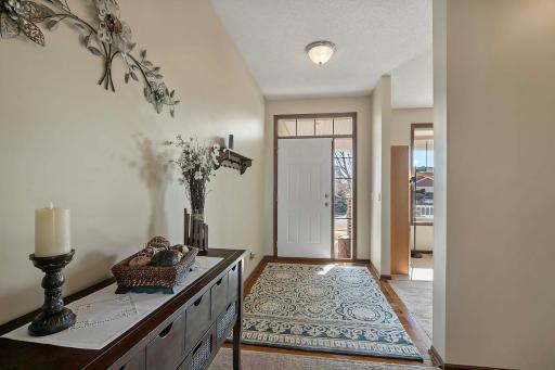 Bright and open foyer with views of front and back of home.