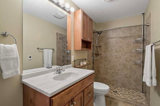 Private lower level bath with walk in shower, heated tile floor and motion sensors for the lighting.