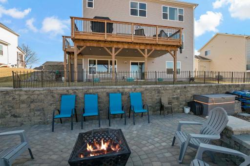 The lower level walks out to the tiled covered patio courtesy of the "under deck system". The rain is diverted to the side. A crank-down sunshade on the west side of the patio not only provides late afternoon summer shade but also privacy as well.