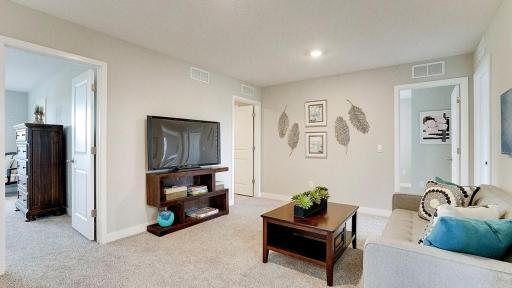 This secondary living space in the upper level is great for family movie night! *Photo is of a model home, colors may vary in actual home.