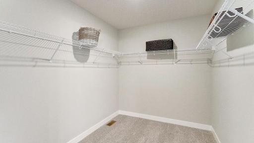 Primary closet! *Photo is of a model home, colors may vary in actual home.