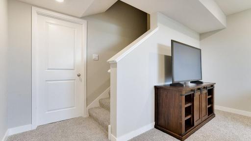 This is a finished basement in a model home; shown in order to give buyer an idea of what the basement space could look like once finished. The basement shown in these photos is of a lookout basement. Home listed is a walkout and is unfinished.