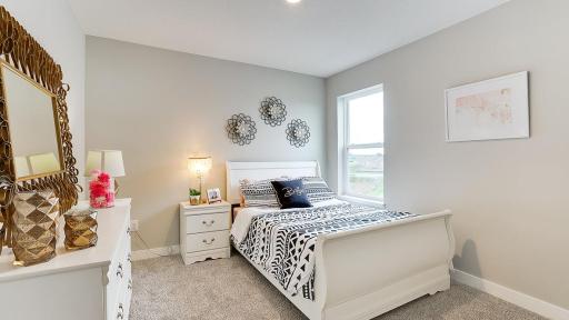 One of three, large, secondary bedrooms. *Photo is of a model home, colors may vary in actual home.