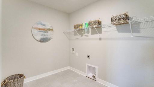 Conveniently located upstairs, near the bedrooms is the laundry room. *Photo is of a model home, colors may vary in actual home.