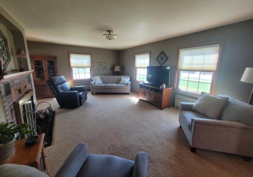 Spacious carpeted living room with plenty of natural light.