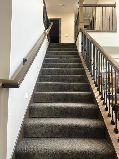 Staircase leads to 4 bedrooms, 1 full bathroom and a second laundry area.