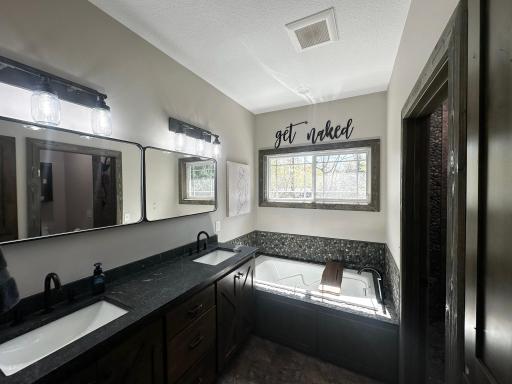 Bathroom with heated floors, double vanity, jetted tub and walk-in /shower.