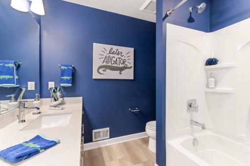 (*Photo of decorated model, actual homes colors and finishes will vary) This stunning full bath is one of two baths located on the home’s upper level.