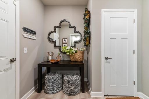 (*Photo of decorated model, actual homes colors and finishes will vary) The spacious mudroom is conveniently located just off the garage entrance to the home